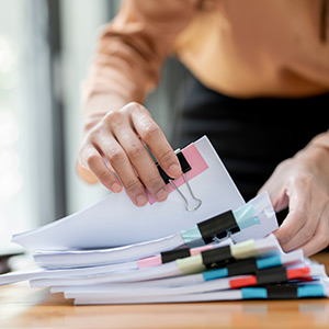 Plant health expert inspecting a melon with a loupe